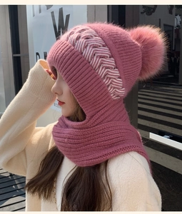 Detail of pink knitted balaclava hood with warm neck warmer and decorative pompom