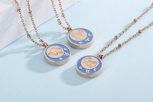 Detailed macro view of three rose gold zodiac coin necklaces with blue enamel finishes