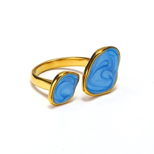 Detail of irregular double-headed gold open ring with marbled blue enamel finish