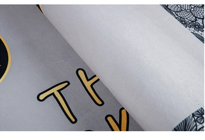 Detailed macro view of gray fabric carpet texture with printed yellow TR letter design