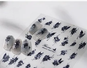 Macro detail of vintage butterfly and floral nail stickers with tiny silver rhinestones