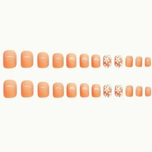 24 faux ongles pieds rose orangé avec motifs floraux blancs et détails argentés