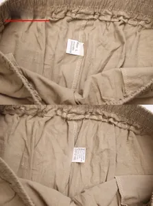 Detail of elastic waistband and care label showing 95% linen material on khaki trousers