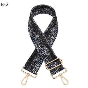 Close-up of leopard pattern bag strap with golden metal clasps and adjustable buckle