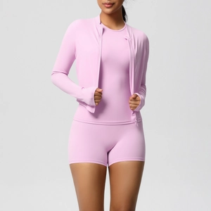 Detail view of pink three-piece yoga set with zip jacket, tank top, and high waist shorts