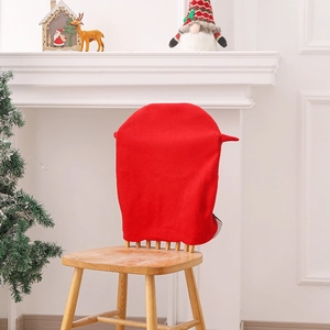Red Christmas chair cover with Santa hat design in cozy festive home interior setting