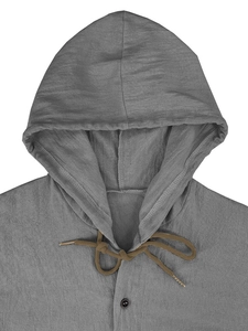 Detail view of grey linen hooded shirt featuring a brown drawstring and black neck button