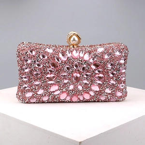 Detailed view of pink rhinestone evening clutch featuring a pearl metal ring clasp