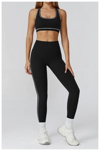 Close-up of contrast white side stripes on black yoga sports vest and high-waist leggings