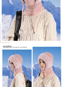Pink winter knit hood with faux fur trim shown against a snowy outdoor background
