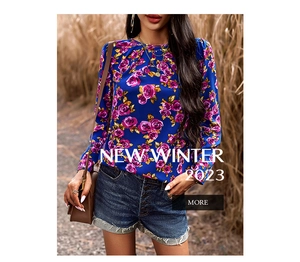 Close-up of royal blue floral blouse with purple rose print and smooth chiffon texture