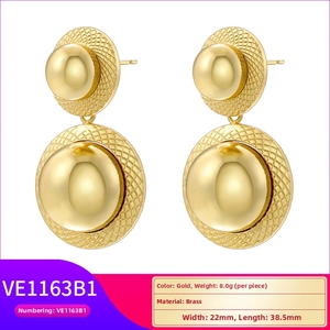 Detailed view of gold geometric brass stud earrings with spherical design and grid texture