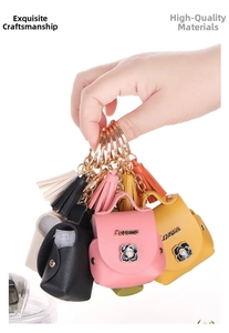 Close-up of colorful PU leather earphone case keychains with tassels and floral charms
