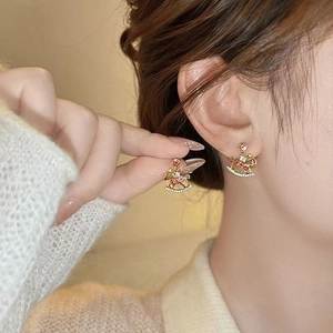 Charming golden rocking horse stud earrings with red accents and sparkling crystals