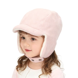 Detail of pink corduroy winter trapper hat with soft faux fur lining and earflaps