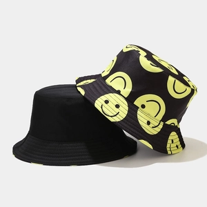 Reversible bucket hat set with black fabric and yellow smiley face print for sun protection