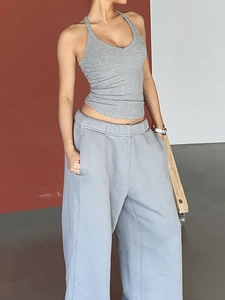 Detail of high-stretch grey racerback tank top and light blue-grey yoga sweatpants set