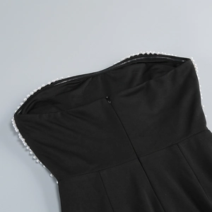 Close-up of black strapless evening gown with white pearl trim and invisible zipper