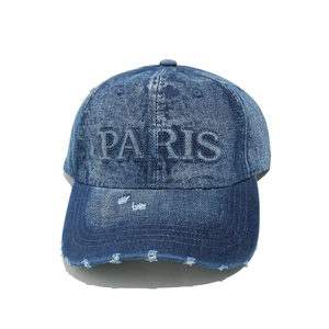 Close-up of distressed denim baseball cap with 3D Paris embroidery and vintage style