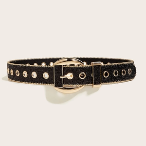 Close-up of black glitter belt with oval golden buckle and metallic eyelets detailing
