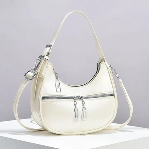 Minimalist beige crescent hobo shoulder bag with silver hardware and smooth leather texture