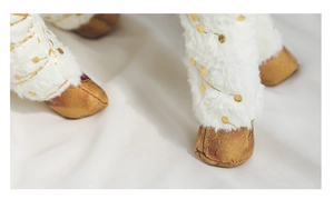 Close-up of reindeer plush legs with fluffy white fur and golden hoof details