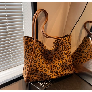 Fashionable leopard print canvas tote bag with brown leather straps and spacious interior