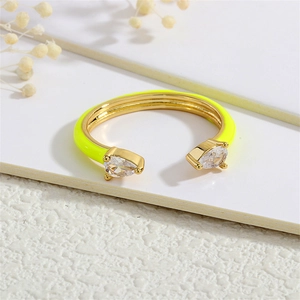 Detail of adjustable gold ring featuring dual pear-cut cubic zirconia and oil-dripped finish