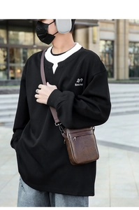 Close-up of brown PU leather crossbody bag with adjustable wide strap and front zipper