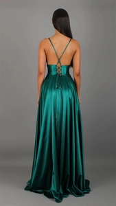 Detail of cross back straps and flowing dark green satin fabric on the floor-length dress