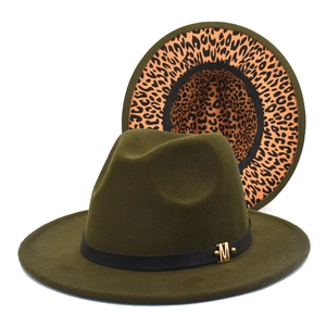 Detail of army green fedora hat featuring gold M buckle and leopard print underbrim