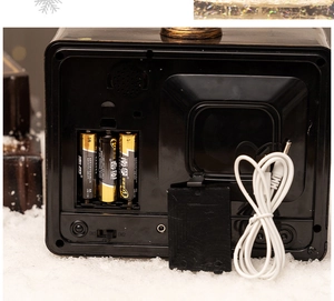 Dual power detail of vintage TV music box with battery compartment and DC cable