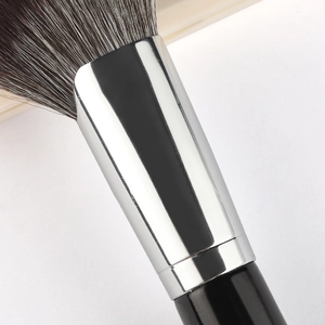 Sickle-shaped contour brush with soft gradient bristles and a polished silver ferrule
