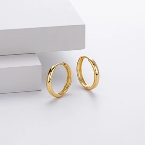 Macro detail of gold S925 sterling silver hoop earrings with 925 hallmark stamp