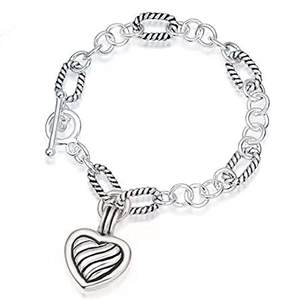 Detail of silver heart charm bracelet with twisted links and OT toggle clasp