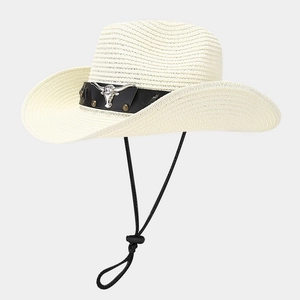 Detail of white straw cowboy hat showing leather band with bull head metal emblem and chin cord