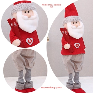 Detail of Santa plush featuring red knit sweater and gray corduroy pants with wood buttons