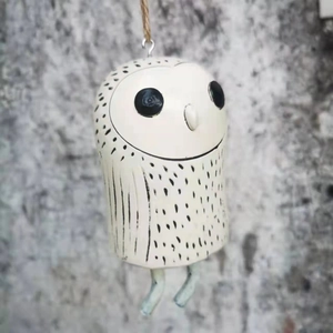 Close-up of handmade white owl garden wind chime with rustic hemp rope hanger