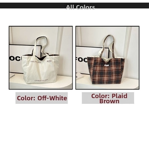 Detail of reversible canvas tote bag showing off-white text side and brown checkered side