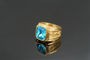 Detailed view of a golden dragon ring featuring a rectangular blue sapphire gemstone