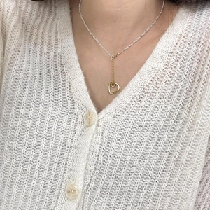 Close-up of minimalist S925 sterling silver Y-shaped necklace with heart pendant