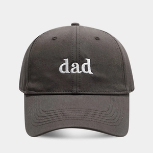 Detailed close-up of white DAD letter embroidery on dark grey twill cotton baseball cap