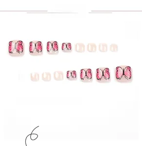 Detailed set of pink press on toenails featuring butterfly art and glossy finish