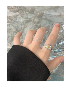 Detail of silver S925 heart ring with moonstone and colored cubic zirconia on finger