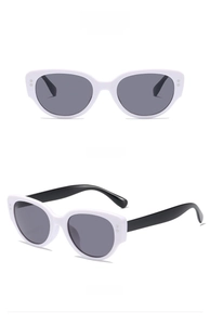 Cat eye sunglasses detail with white frame black temples and dark grey lenses