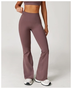 Detail view of high-waist flared yoga pants with reinforced seams in purple fabric