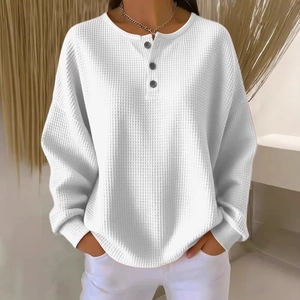 White waffle knit long sleeve crewneck top with button detail on a female model