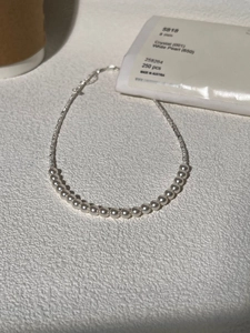 Detail view of 8mm white pearls and silver beads on a high-quality choker necklace