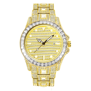 Macro detail of gold luxury watch featuring rainbow rhinestones and date display
