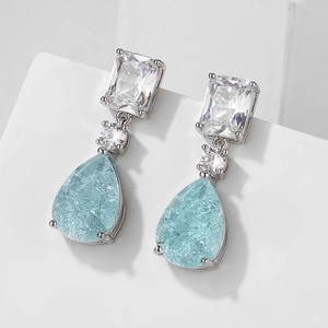 Silver drop earrings featuring light blue pear-cut faux Paraiba stones on stone block